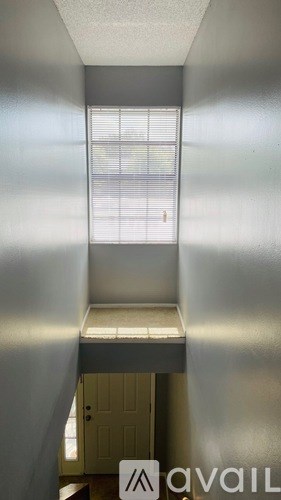 A room with a window and a door.