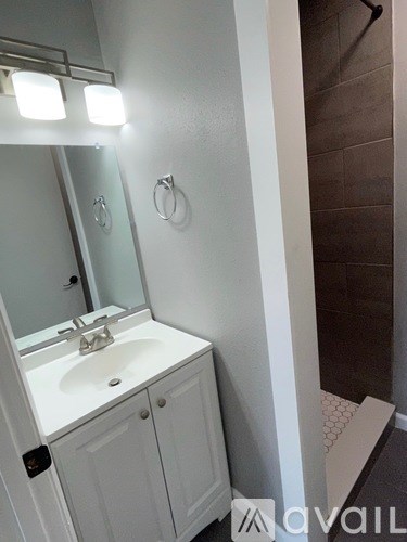 A bathroom with a sink and mirror.