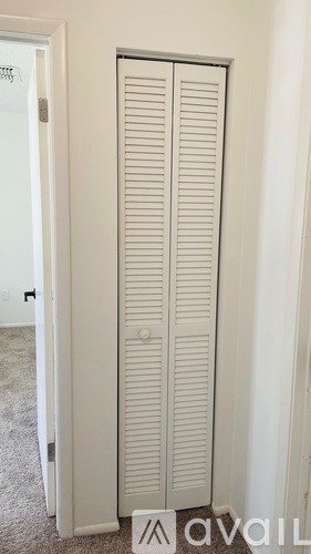 Closed white shutter doors in a room.