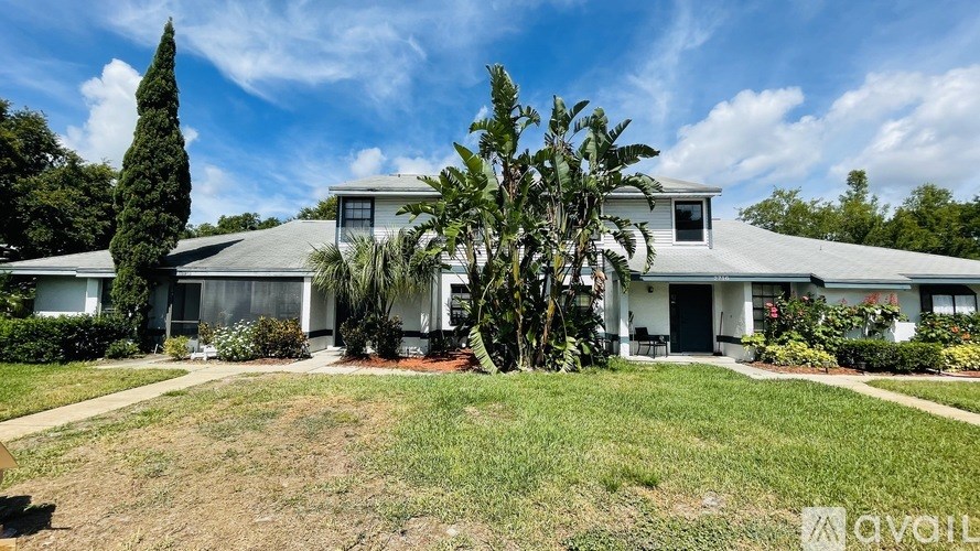 A house with a tree in front of it is for sale.