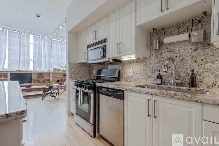 A kitchen with granite countertops and stainless steel appliances.