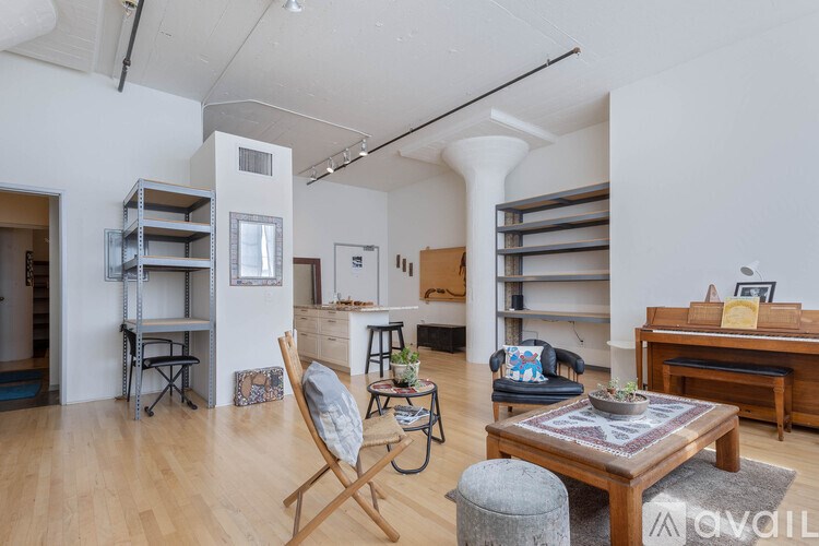 A living room with a wooden floor and furniture.