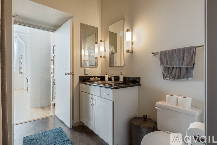 A bathroom with a white tub, sink, and toilet.