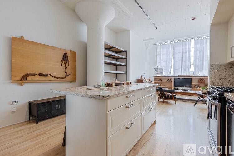 A kitchen with a white counter and wooden cabinets.