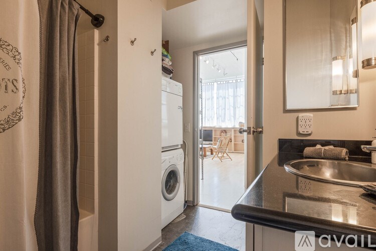 A modern kitchen with a washing machine in the corner.