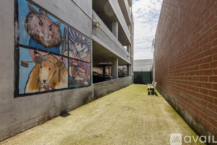 A mural of a bear and a dog on a concrete wall.