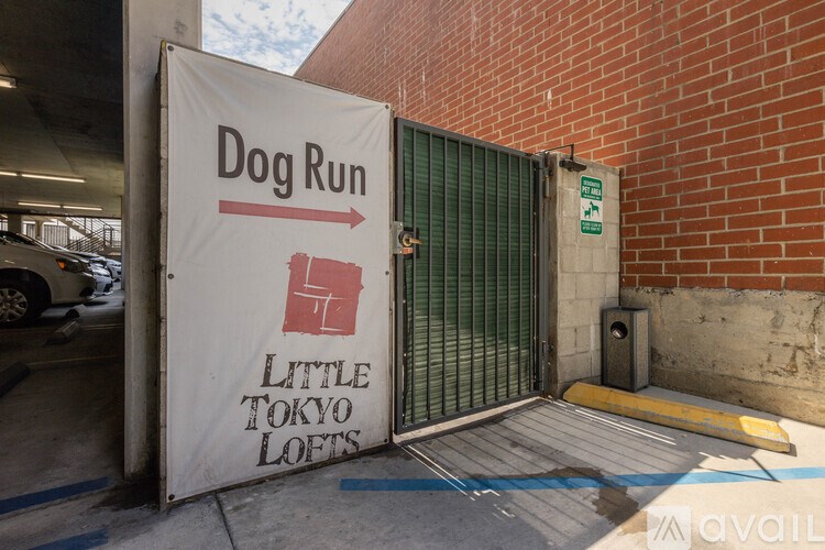 A sign for a dog run is displayed on a wall.