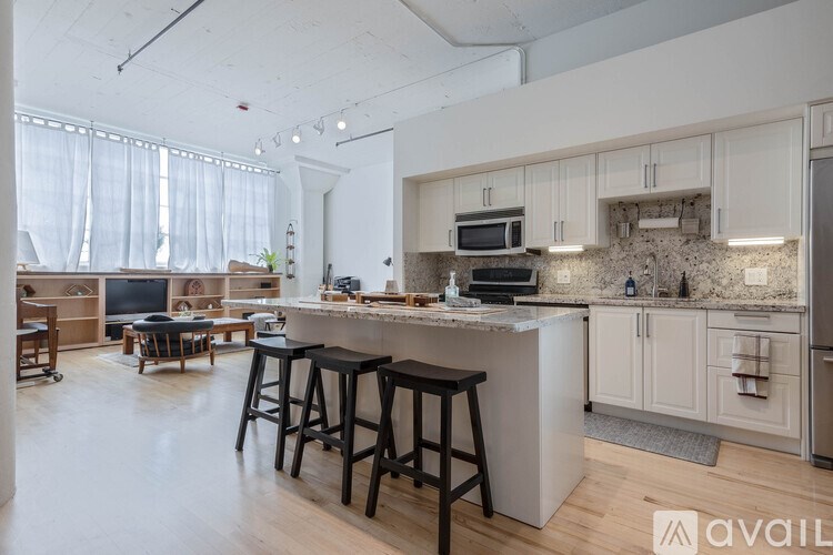 A kitchen with a bar area and a dining table.