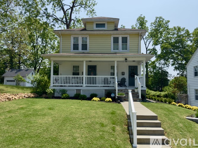 A two-story house with a white porch.