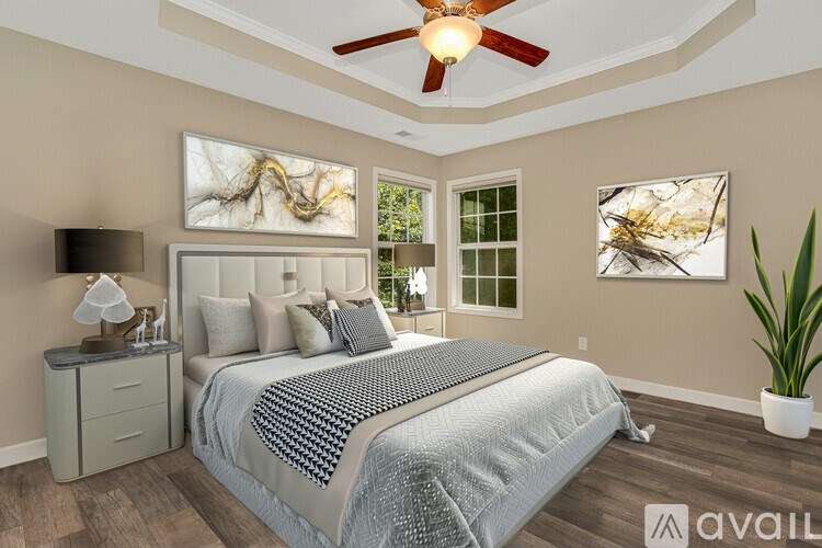 A bedroom with a bed, nightstand, and a ceiling fan.