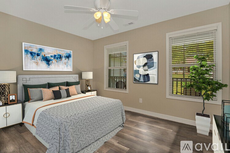 A bedroom with a large bed and a painting on the wall.