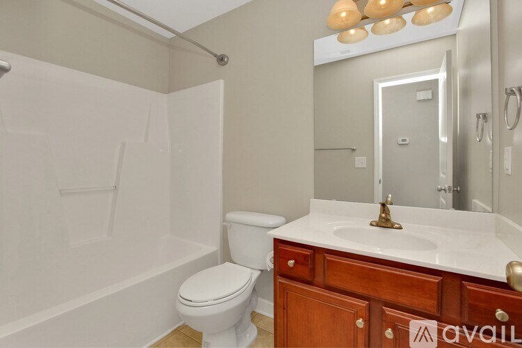 A bathroom with a toilet, sink, and bathtub.