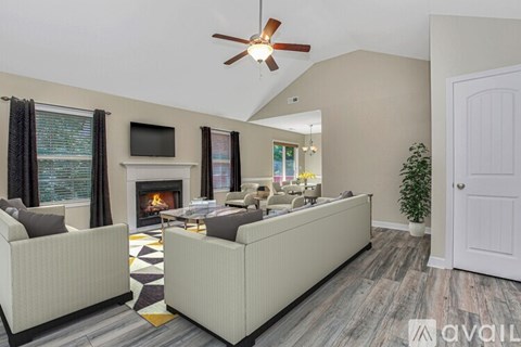 A living room with a fireplace and a television on the wall.