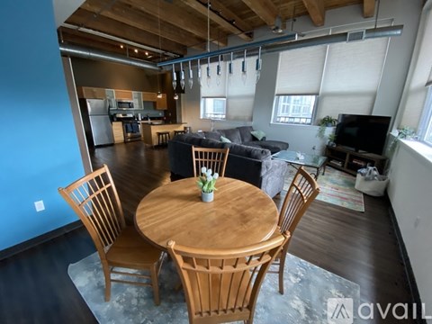 A dining room with a wooden table and chairs.