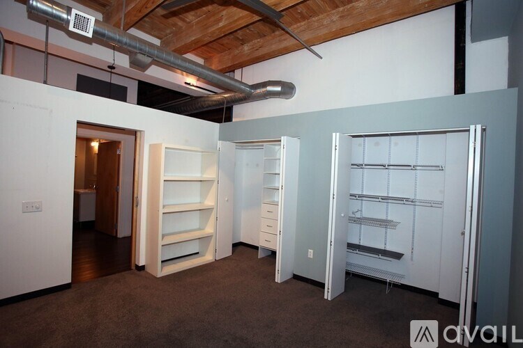 A room with a white wall and a white shelving unit.