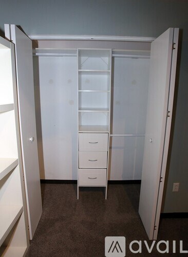 A white closet with drawers and shelves.