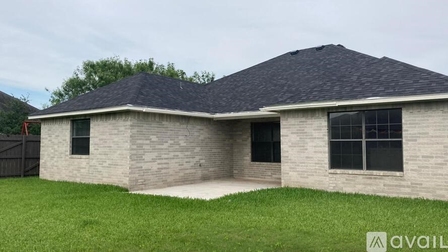 A house with a grey roof and a sign that says "available" in the front yard.