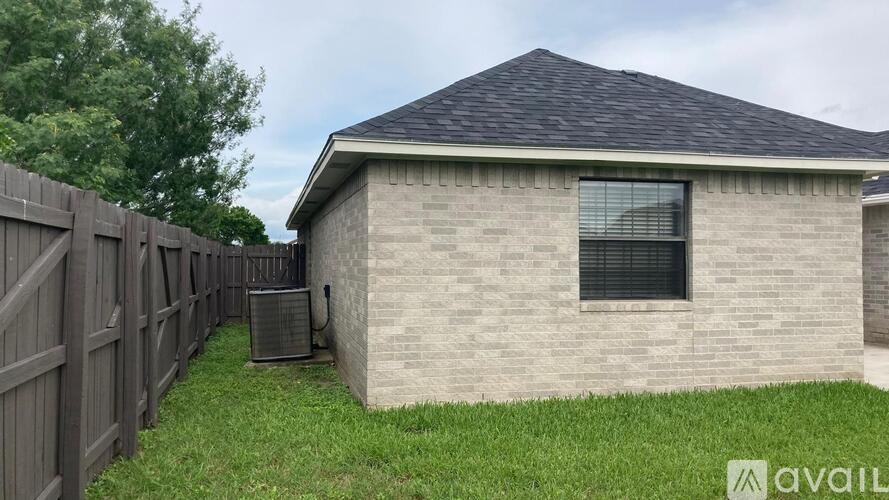 A house with a fence and a window is for sale.