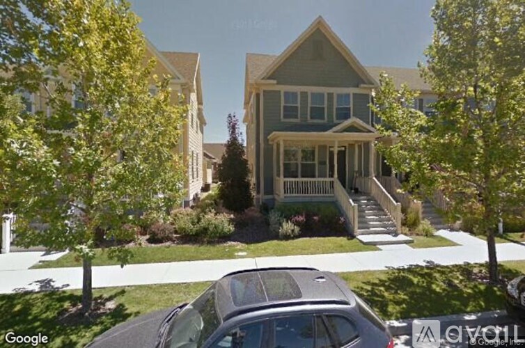 A house with a car parked in front.