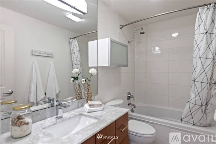 A bathroom with a white sink and a white toilet.