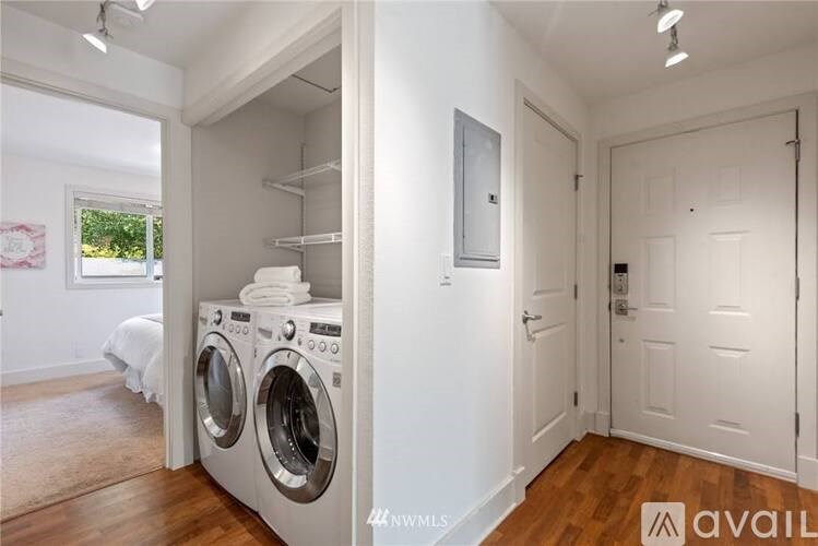 A small laundry room with a washer and dryer.
