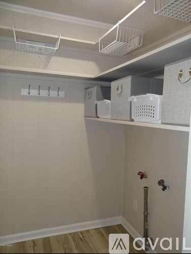 A white laundry room with a washer and dryer.