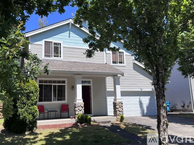 A blue house with a red door and white columns.