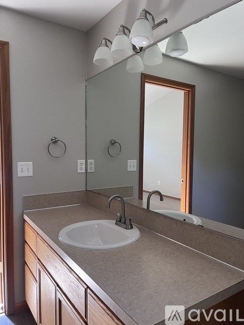 A bathroom with a sink and mirror.