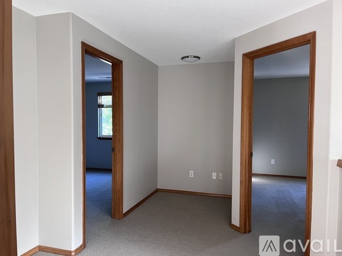 A room with a carpeted floor and white walls.