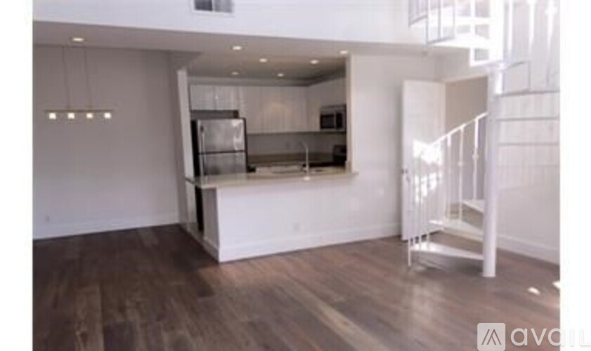 A kitchen with a refrigerator, stove, and oven is available for rent.