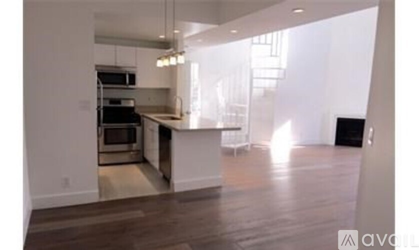 A kitchen with a stainless steel oven and a white countertop.