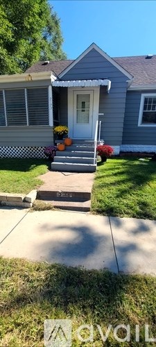 A house with a grey front yard and a white door.