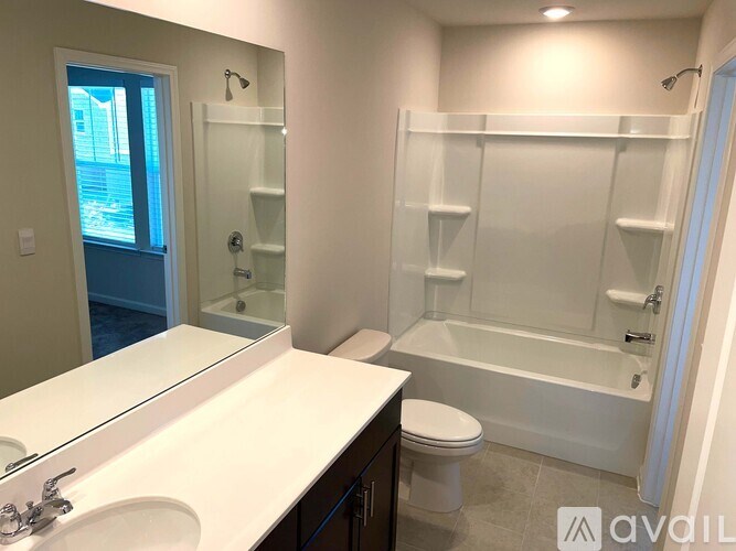 A bathroom with a toilet, sink, and bathtub.