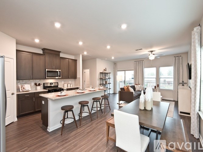 A spacious kitchen with a bar area and a dining table.