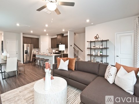 A living room with a grey couch and a white coffee table.