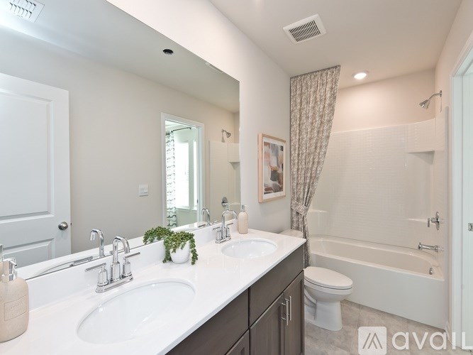 A bathroom with a white countertop and a white toilet.