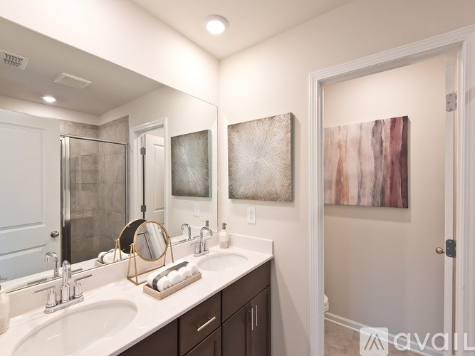 A bathroom with a white sink and a mirror above it.