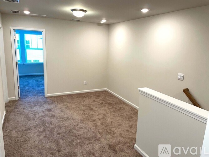 A room with carpeted floor and white walls.
