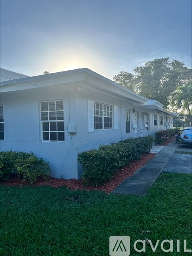A white house with a sun shining in the background.