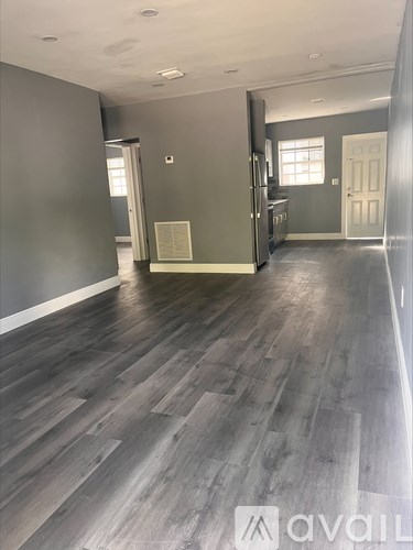 A room with wooden flooring and a plaque on the wall.