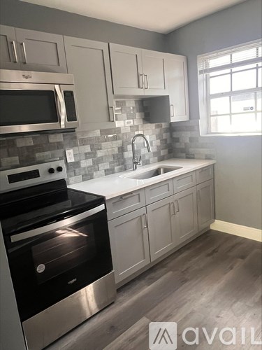 A kitchen with a stove top oven and a microwave.