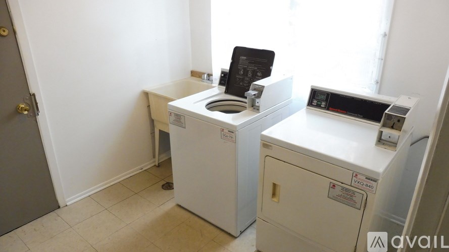 A room with a washing machine and a dryer.