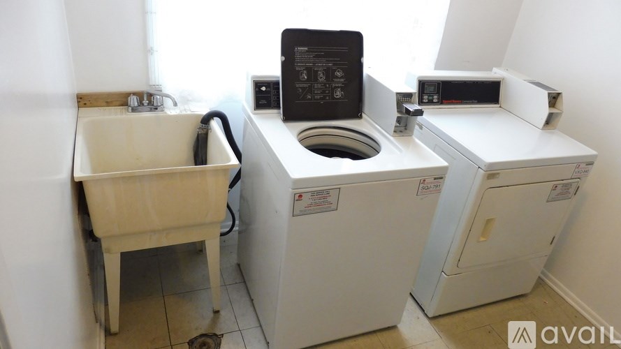 A white washing machine and dryer in a small room.