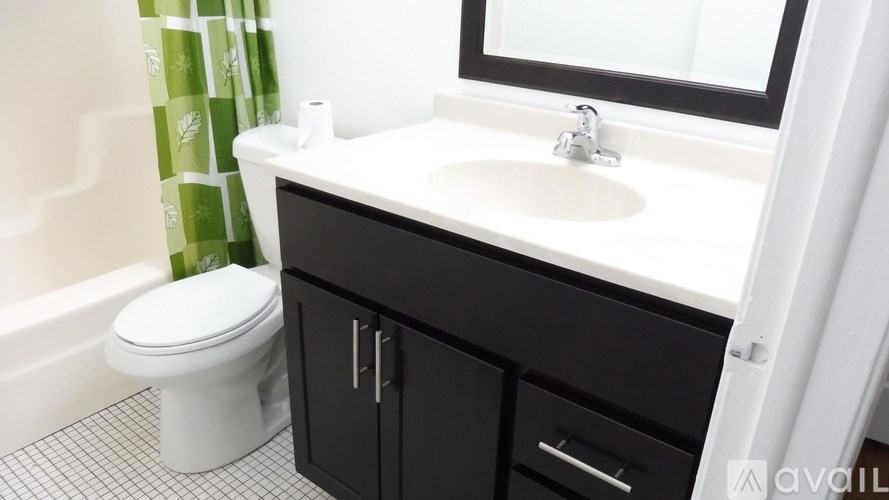 A white toilet sits next to a sink in a bathroom.