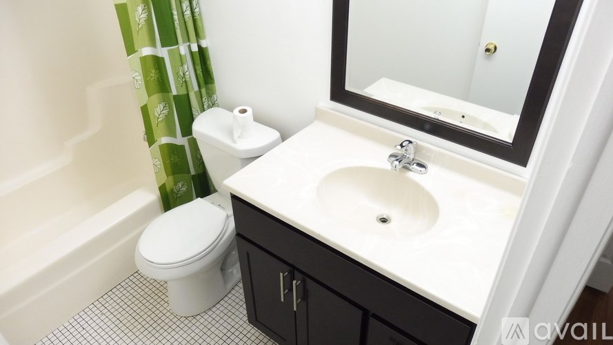 A white toilet sits next to a sink in a bathroom.