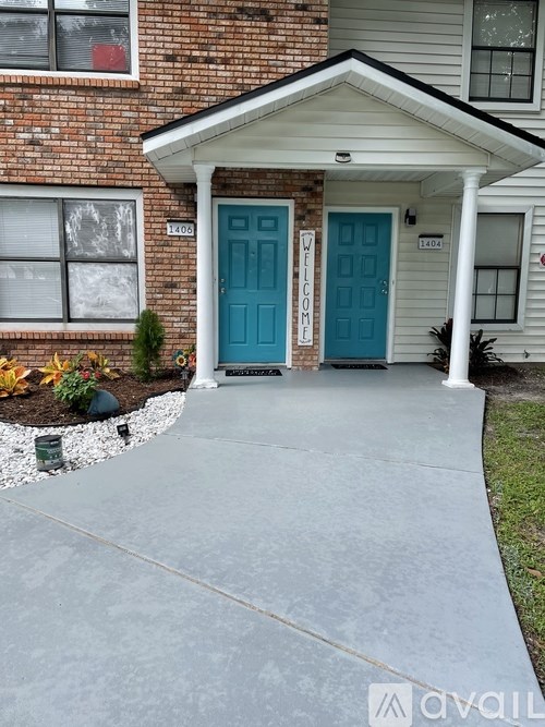 A house with a blue door and a white porch.
