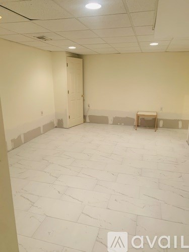A room with a white tile floor and a door.