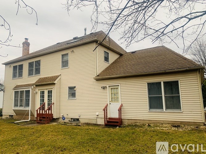A house with a brown roof and a white door is for sale.