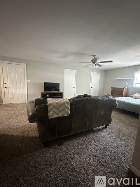 A living room with a couch and a television.
