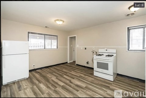 A kitchen with a white fridge, stove and oven.